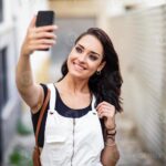 girl takes selfie on smartphone